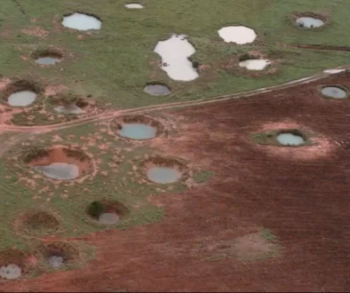 What appears to be ponds are actually water-filled bomb craters from the Vietnam War era, as seen from a helicopter in 1997 near the northeastern Laotian village of Sam Neau.